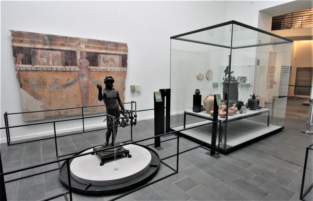 Una sala del museo Antiquarium con Efebo portalucerna in bronzo trovato nella Casa di Marco Fabio Rufo