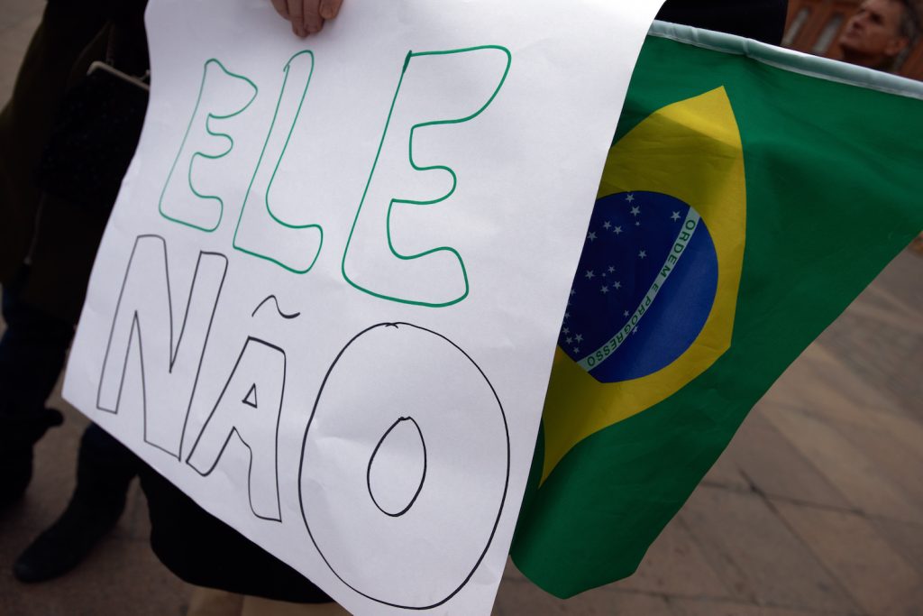«Non lui», riferito a Bolsonaro , è scritto su uno striscione di protesta a San Paolo (AFP)
