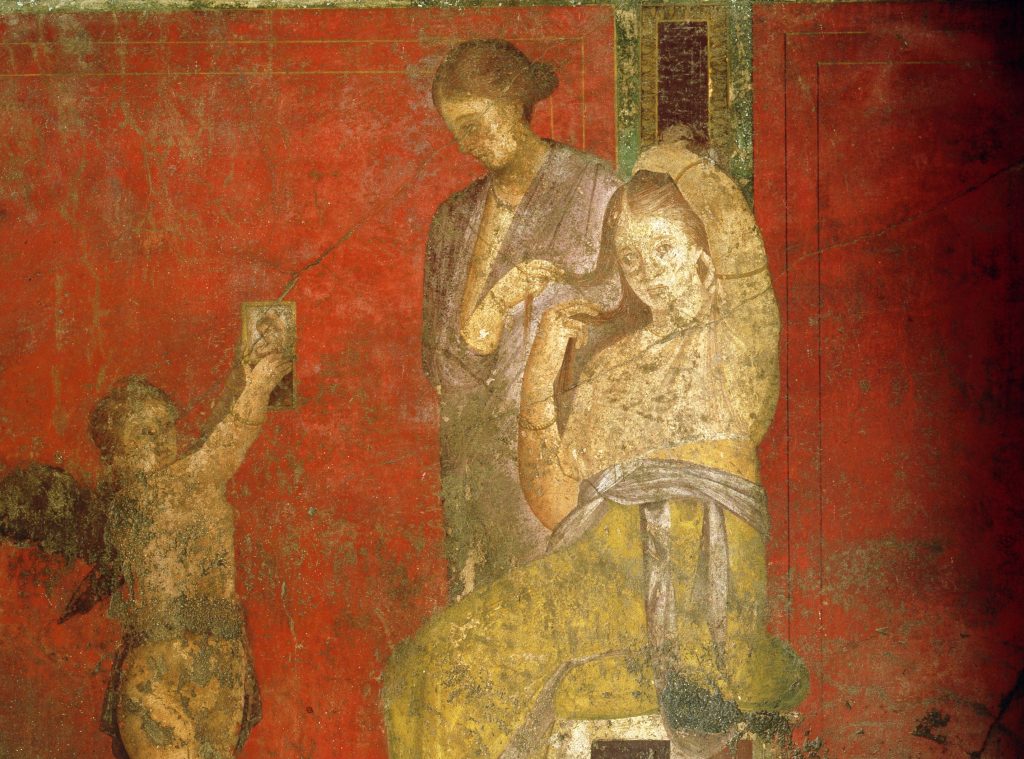 Una donna lava i capelli a un’altra nella Villa dei Misteri di Pompei (Keystone)