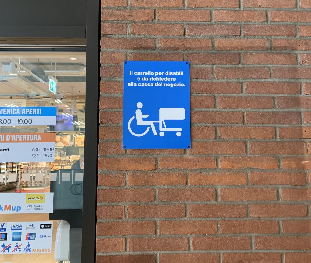 Il cartello all’ingresso della filiale Migros di Molino Nuovo (S.Sala)